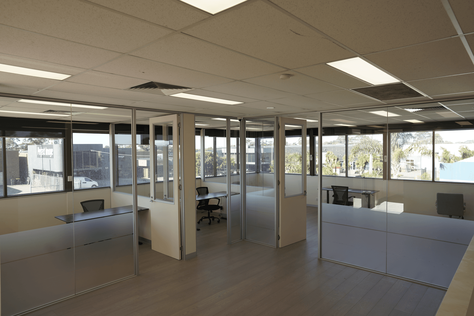 Pickle4Real private office with reception counter, brand story panel, and pickleball action display walls